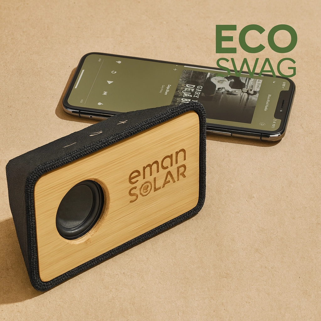 Bamboo Bluetooth speaker with engraved logo placed on a recycled paper background, next to a smartphone playing music.