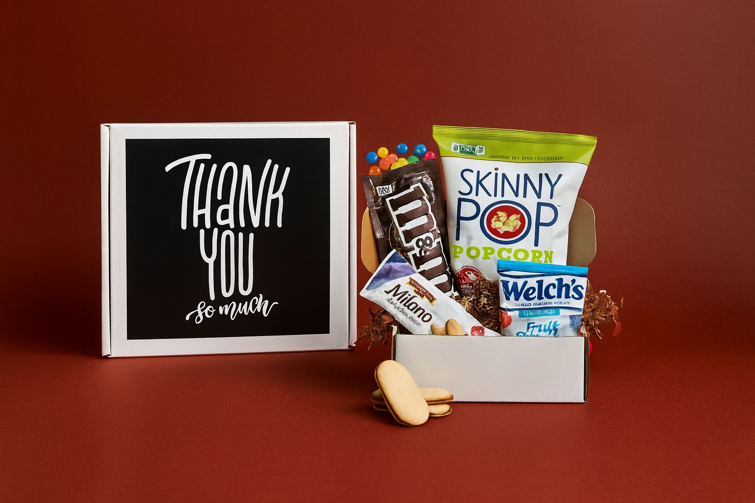 A premium thank-you gift box displayed on a rich red background