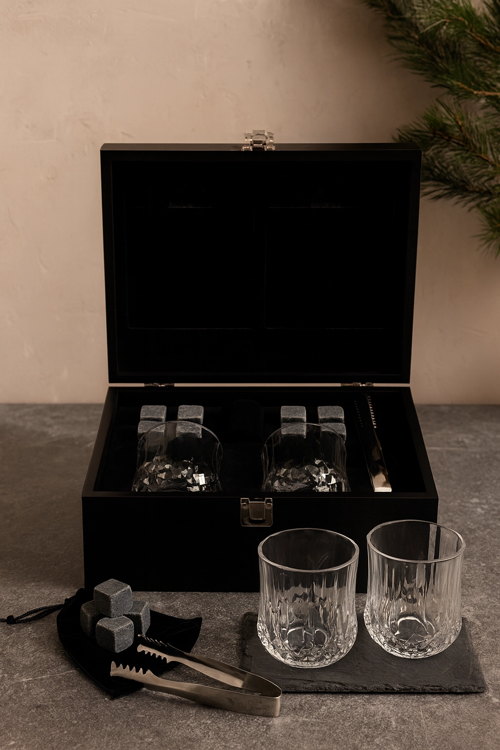 One of the best corporate swag gifts a luxury whiskey gift set with crystal glasses, whiskey stones, and coasters in a black box for executive holiday gifting.